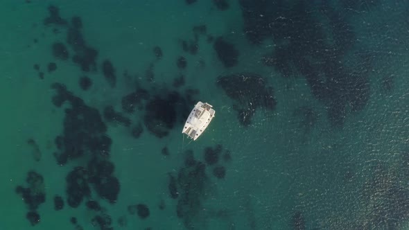 Aerial view of a catamaran anchored in Aegean sea, Greece.