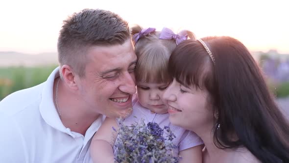 Mom and Dad Kiss Their Baby