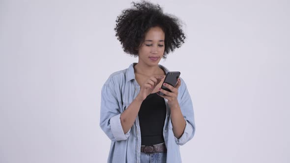 Young Happy African Woman Using Phone and Looking Shocked