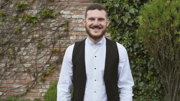 Positive Young Man Smiles at the Camera