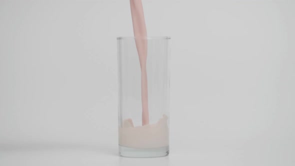 Slow Motion of Pouring Strawberry Milk in Glass at 1000 Fps