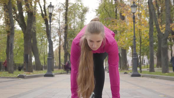 Confident Young Caucasian Woman Looking Up and Starting Running