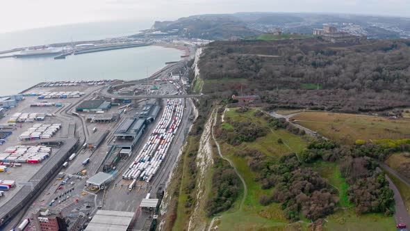 Aerial slider shot of trucks queueing at dover to calais harbour brexit