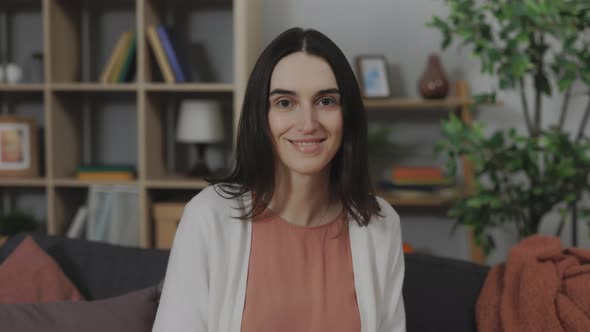 Portrait of Pleasant Caucasian Woman Sitting on Couch