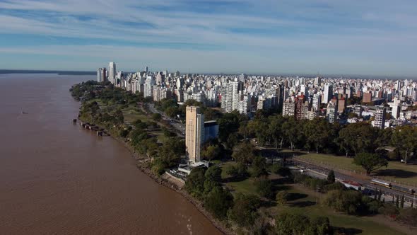 drone flight over the river parana with a view of the huge city of rosario with its high buildings i