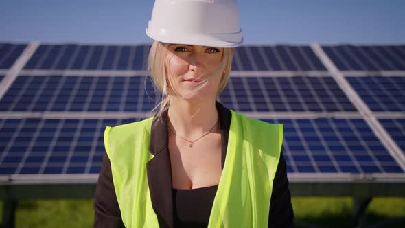 Portrait of Happy Female Engineer in Protective Helmet Looking to Camera