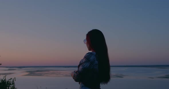 Girl in nature looks thoughtfully into the distance