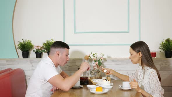 Lovely Couple Spends Time Eating Cakes in Confectionery Shop