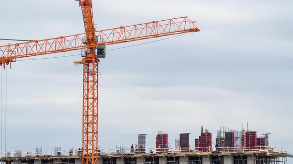 The process of building a monolithic house. Crane and workers