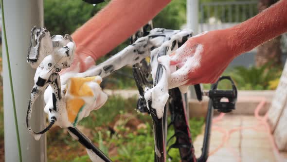 Bike mechanic cleaning bike with soap foam