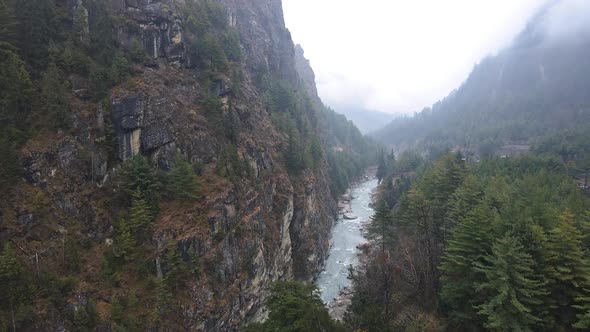 Aerial view flying over the Marsyangdi River through a canyon