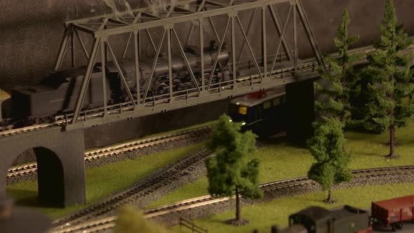 Model Vintage Train Moving Through Bridge.