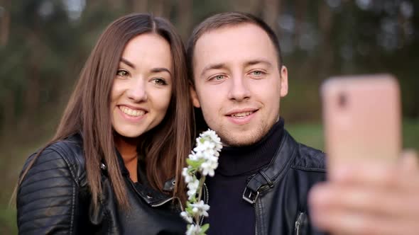 Loving Couple are Photographed on a Smartphone in the Park Selfie Photos