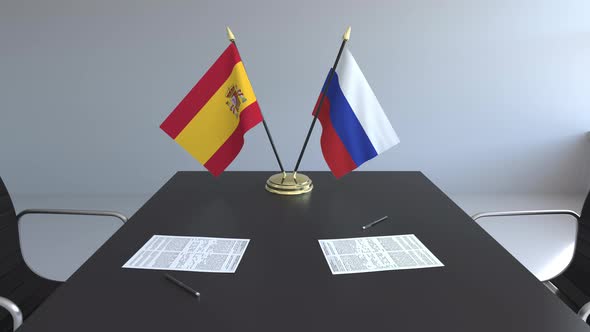 Flags of Spain and Russia on the Table