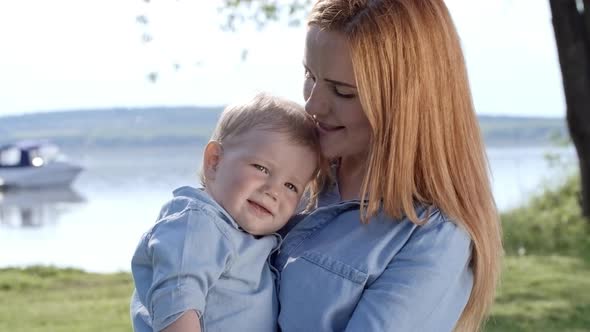 Young Mother Holding Cute Toddler