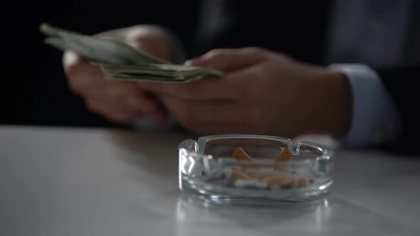 Person in Suit Counting Money and Smoking Cigarette, Illegal Business, Close-Up