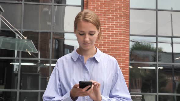 Walking Woman Busy Using Smartphone on Street in Slow Motion