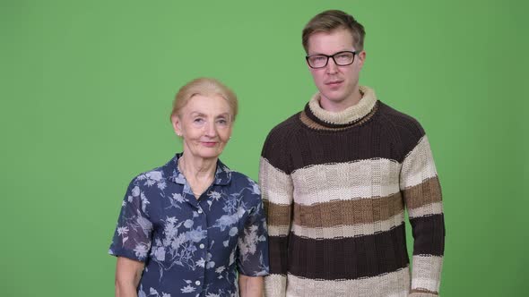 Happy Grandmother and Grandson Giving Thumbs Up Together