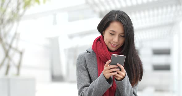 Woman look at mobile phone at outdoor