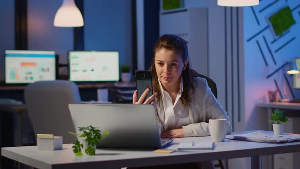 Business Woman Discussing During Video Conference with Partners Using Smartphone