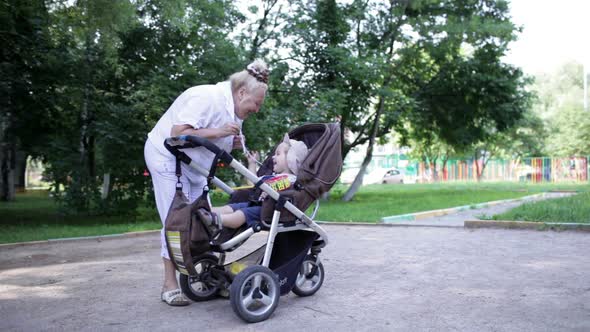 Granny playing with her grandson in the yard