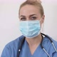 Female Doctor in Mask Looking at Camera - VideoHive Item for Sale