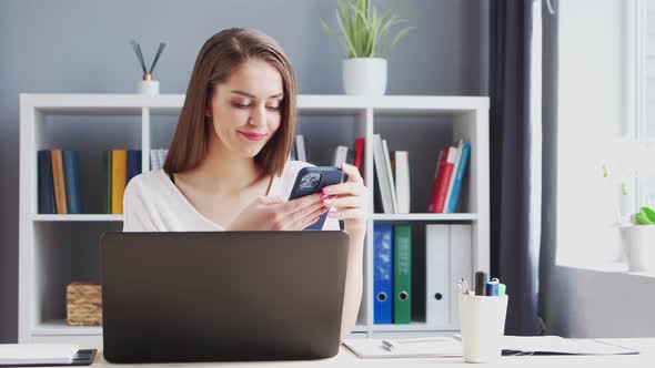 Young Woman Works at Home Office Using Computer.