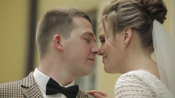 Newlyweds. Caucasian Groom with Bride Making a Kiss. Wedding Couple. Man and Woman in Love