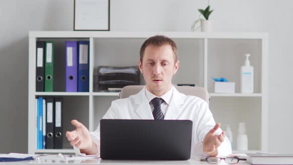 Professional medical doctor working in hospital office using computer technology.