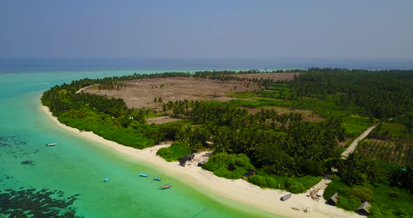 Tropical birds eye travel shot of a white sand paradise beach and blue sea background in colorful 4K