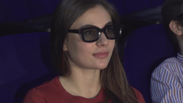 Surprised Girl Takes Off 3D Glasses To Better Consider the Moment in the Movie