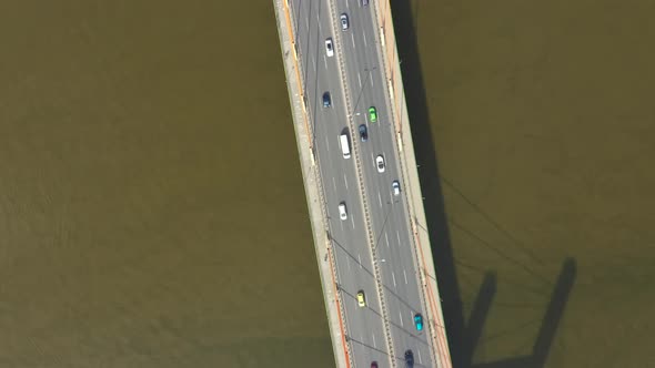 Car traffic on hanging sea bridge over bay in city view from above. Aerial View