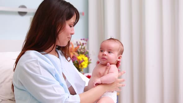 Smiling mother holding a baby