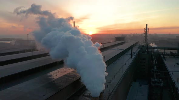 Industrial Zone with Pipe Thick White Smoke Is Poured From the Factory Pipe in Contrast To the Sun