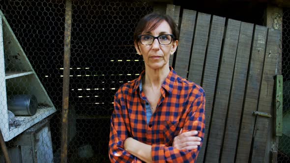 Mature woman standing with arms crossed 