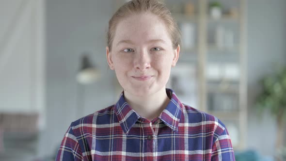 Close Up of Young Woman Shaking Head in Approval