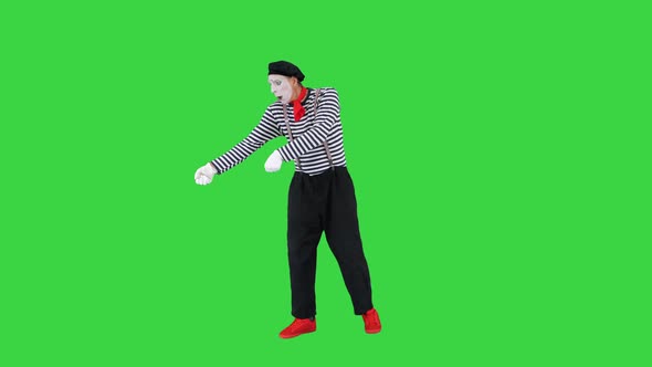 Male Mime Artist Performing Pulling Virtual Rope on a Green Screen Chroma Key