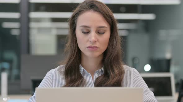 Portrait of Young Businesswoman with Laptop having Neck Pain