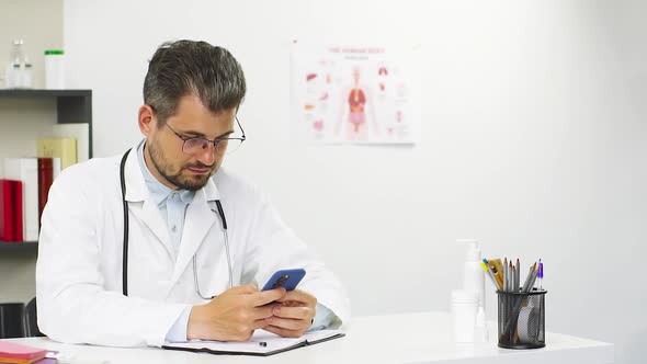 Doctor Using Cell Phone at Hospital