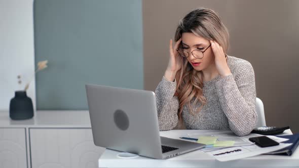 Tired Business Woman Having Migraine Problem at Modern Workplace