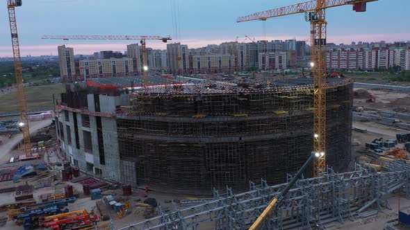 Stadium and Cranes with Glowing Lamp at Construction Site