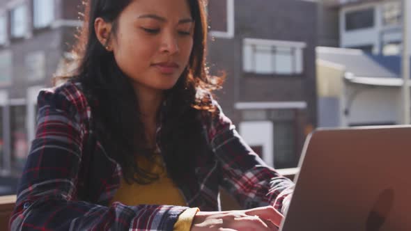 Mixed race woman working on laptop