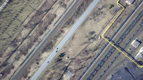 Long row of train cargo cars loaded full with fossil fuel coal.