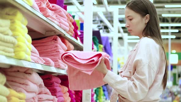 Young Housewife is Buying Towel in Hypermarket