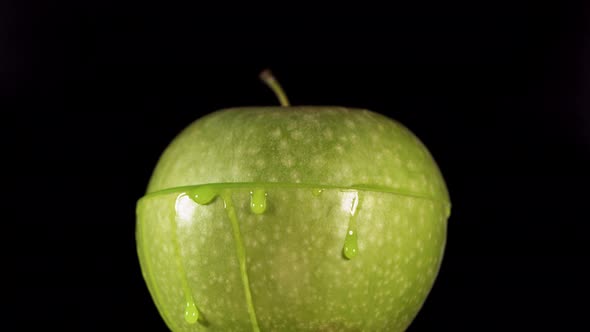 Half Green Apple Falling and Splashing on Black Background