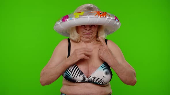 Mature Woman Traveler Dancing Celebrating Posing with Rubber Ring in Swimsuit Bra on Chroma Key