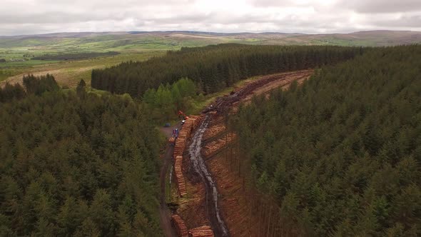 Forestry and logging operations taking place in the highlands of Scotland using large industrial mac