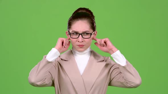 Girl Closes Her Ears From a Sharp Noise. Green Screen. Slow Motion