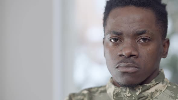 Closeup Face of Serious African American Recruit Looking at Camera