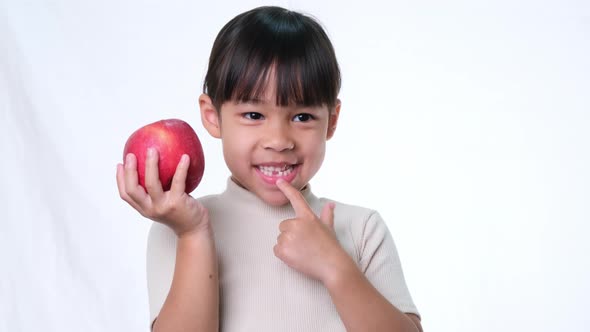 Happy little girl with apple.